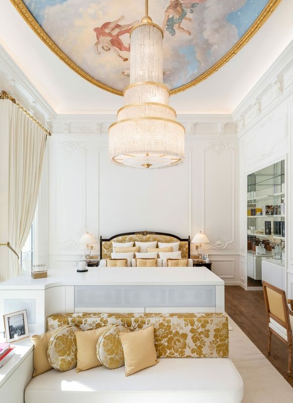 The Versailles-inspired ceiling painting is a dreamy sight in this master bedroom
