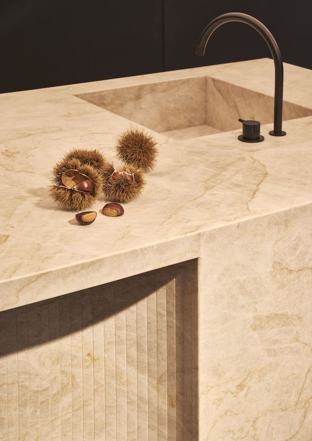 One hundred lightly chamfered stripes form the recessed seating area, nestled within a gentle curve