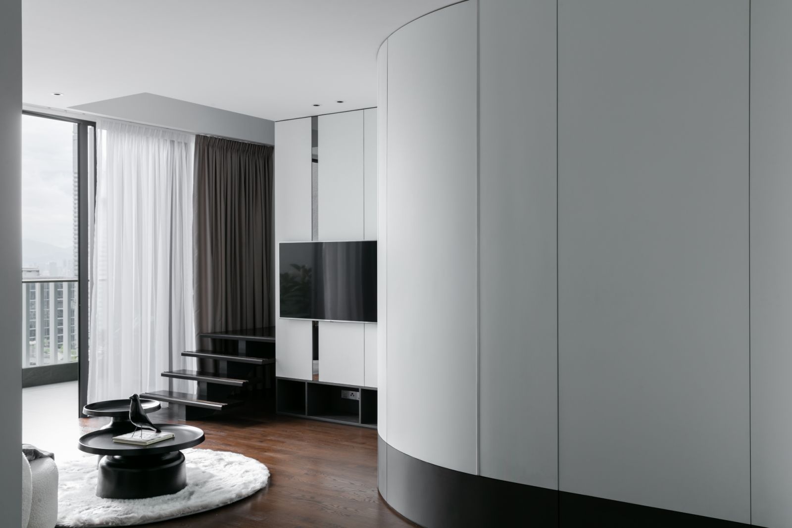 The curved divider conceals the staircase