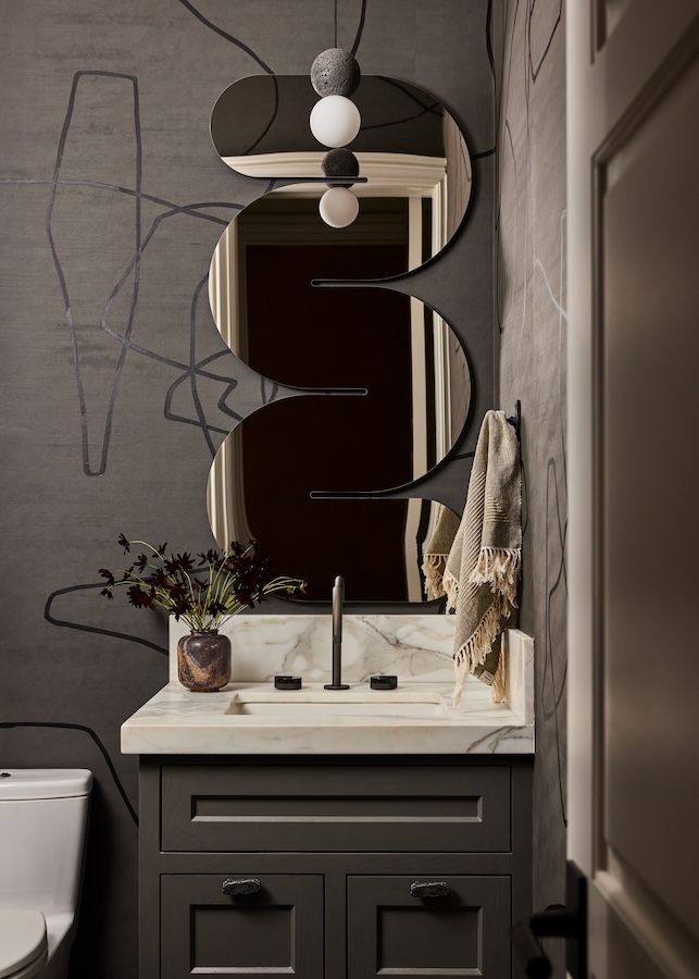 Porter Teleo wallpaper and the squiggly mirror by 9 & 19 provide a fun and grungy look to the powder room