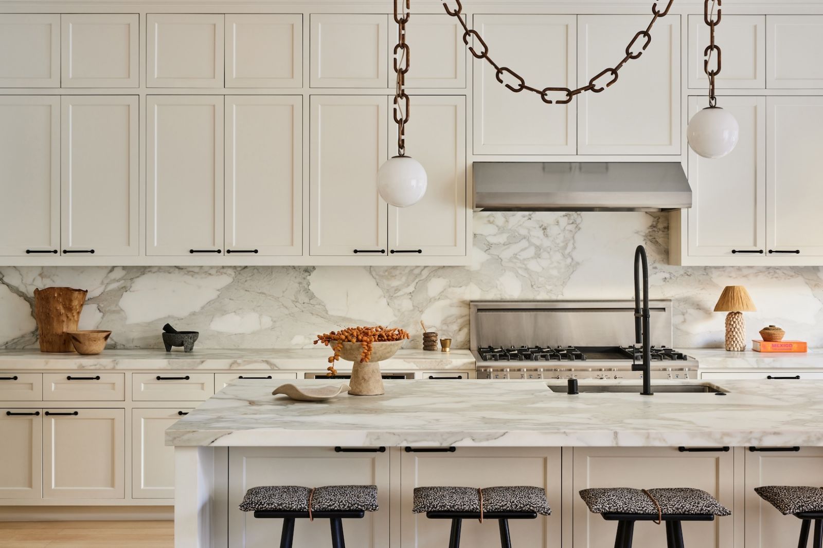 The statement light piece by Trueing and custom cushions by Kvadrat/Raf Simmons truly adds character to the kitchen