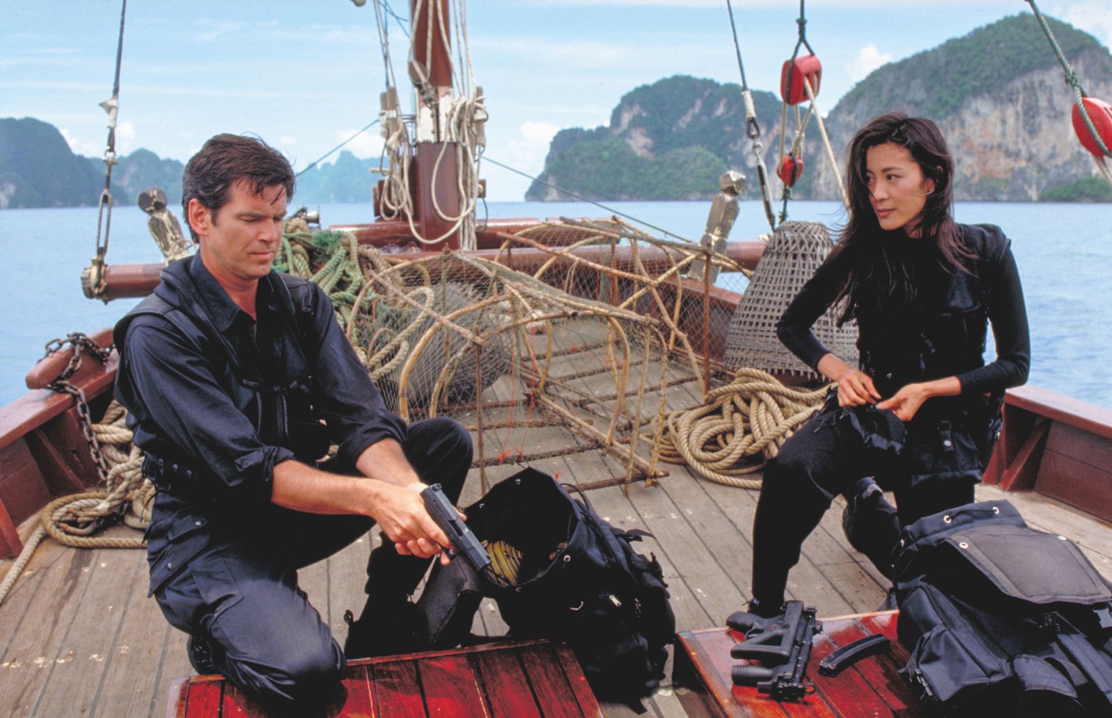 Pierce Brosnan's Bond and spy agent Wai Lin, played by Michelle Yeoh, check their equipment en route to the South China Sea aboard a fishing vessel in 'Tomorrow Never Dies'