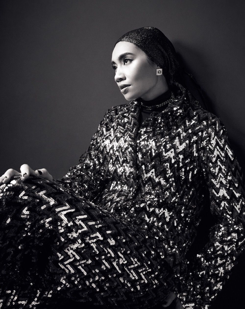 On Yuna: Chanel earrings and necklace, Chanel jacket and pants