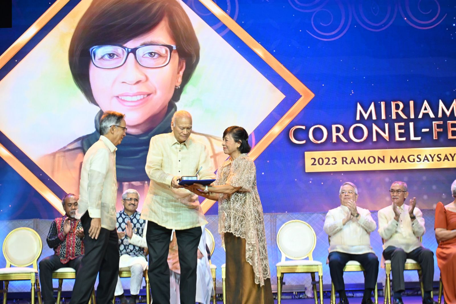 Miriam Coronel-Ferrer of the Philippines receives her medal and certificate by Ramon B Magsaysay Jr, son of the late president, and Foundation chairman Aurelio Luis Montinola III