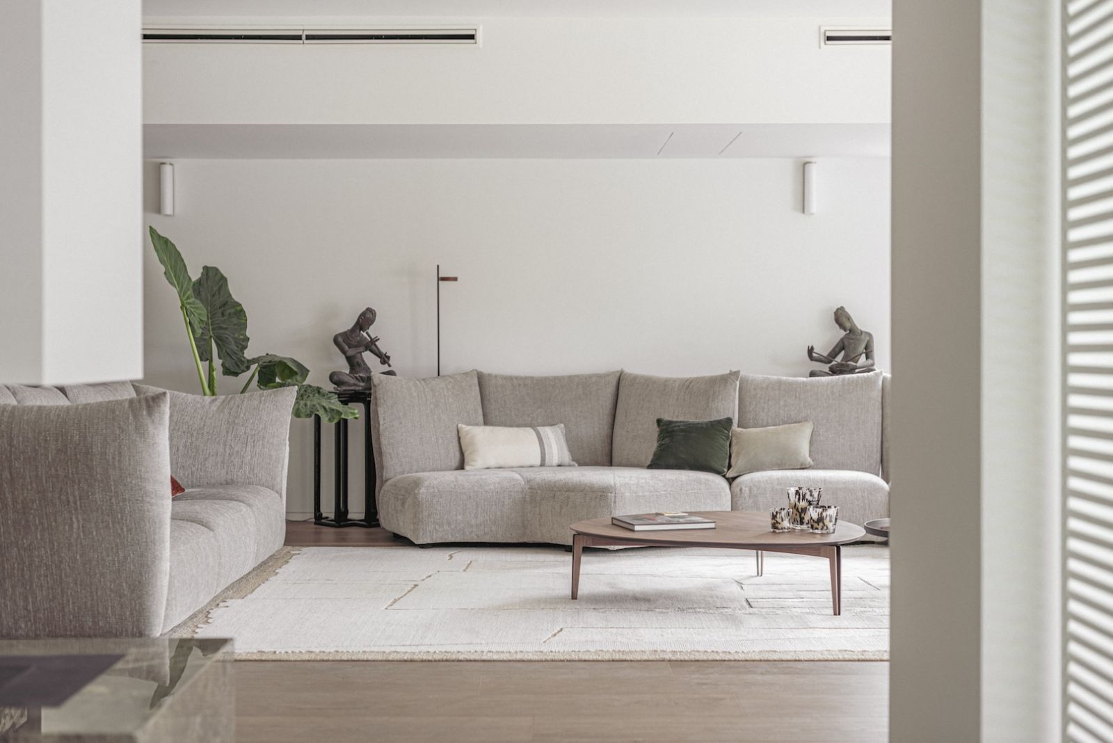 Grey and white hues provide a relaxing ambiance in the open living room