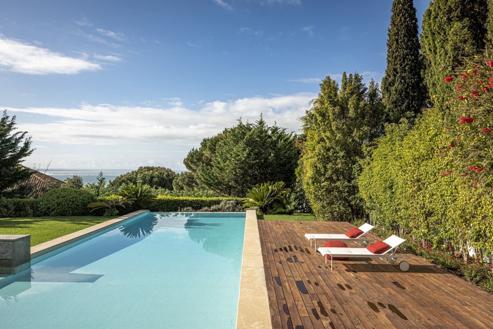 Blue skies and greenery frame the pool area