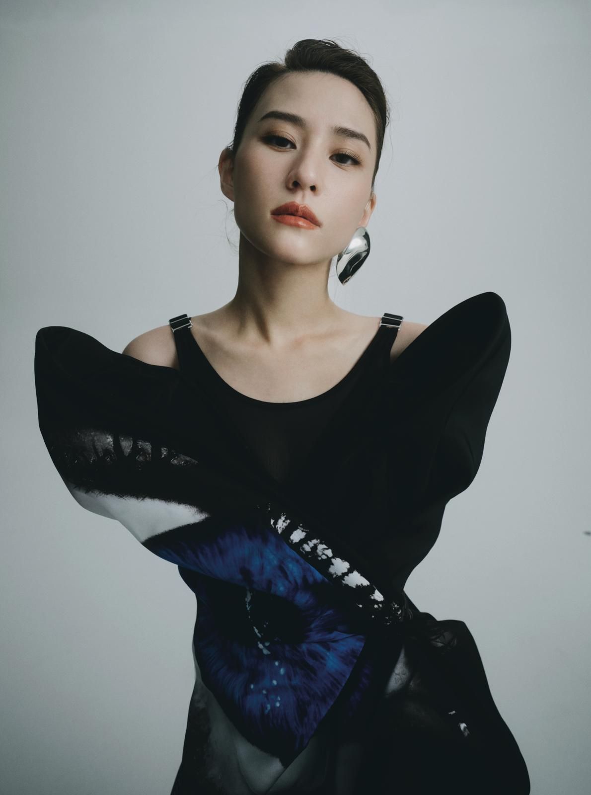 Laurinda Ho in Alexander McQueen dress, earrings, boots.