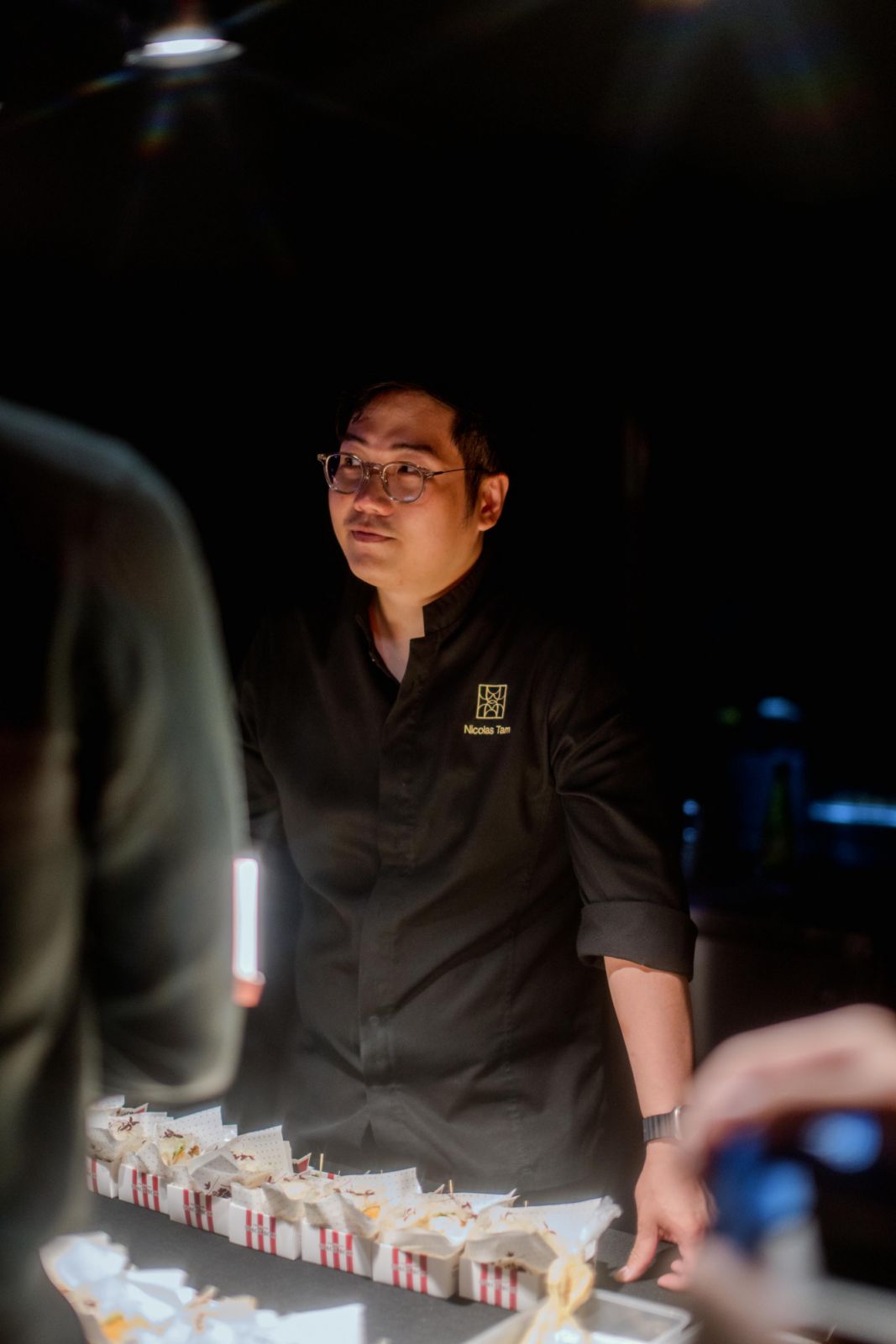 Nicolas Tam chatting with diners at his booth
