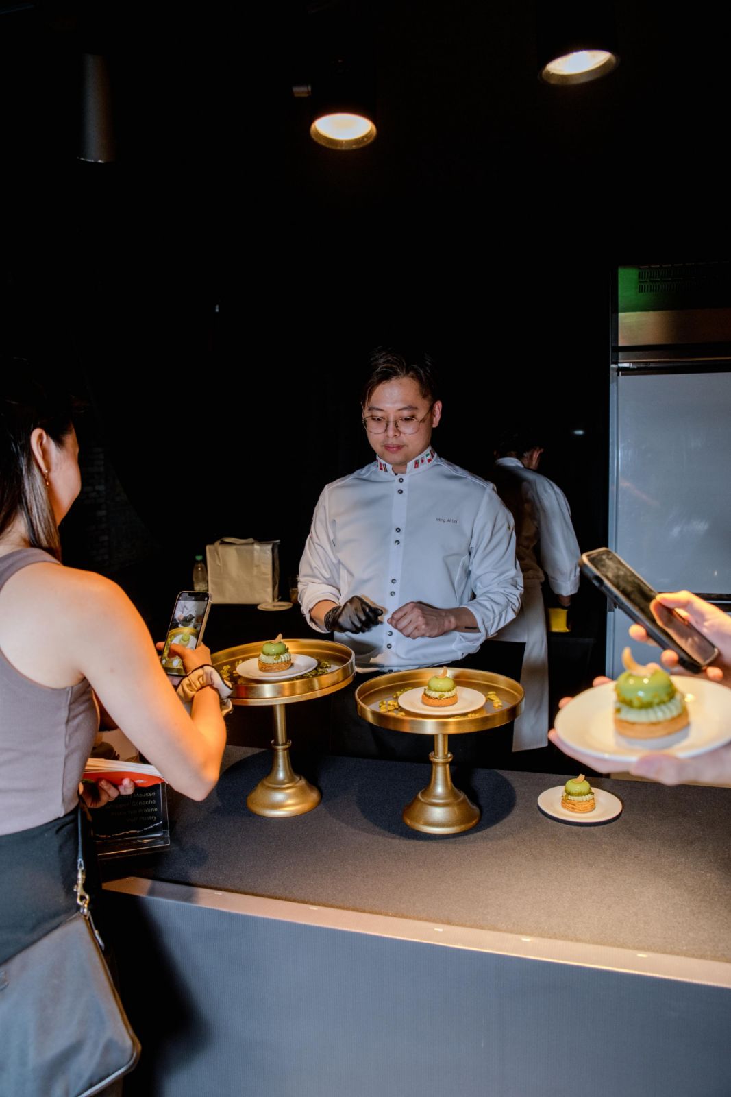 Loi Ming Ai of Voilà Patisserie with diners at his dessert booth