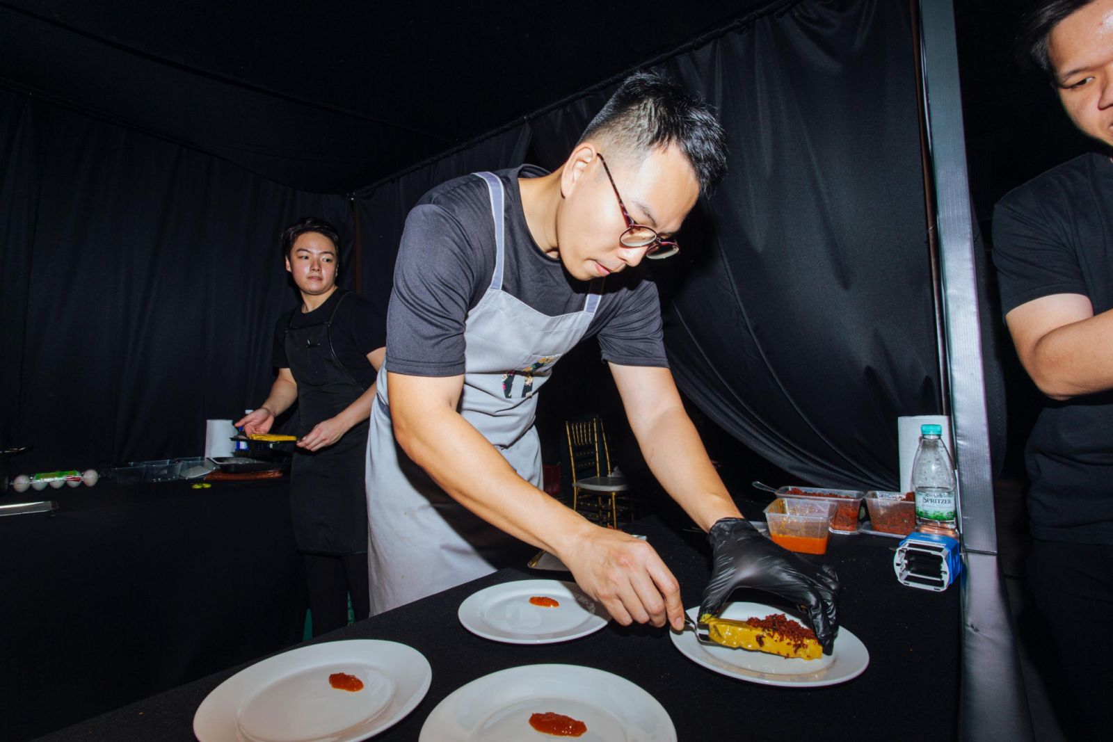 Mark Tai carefully plating his confit chicken