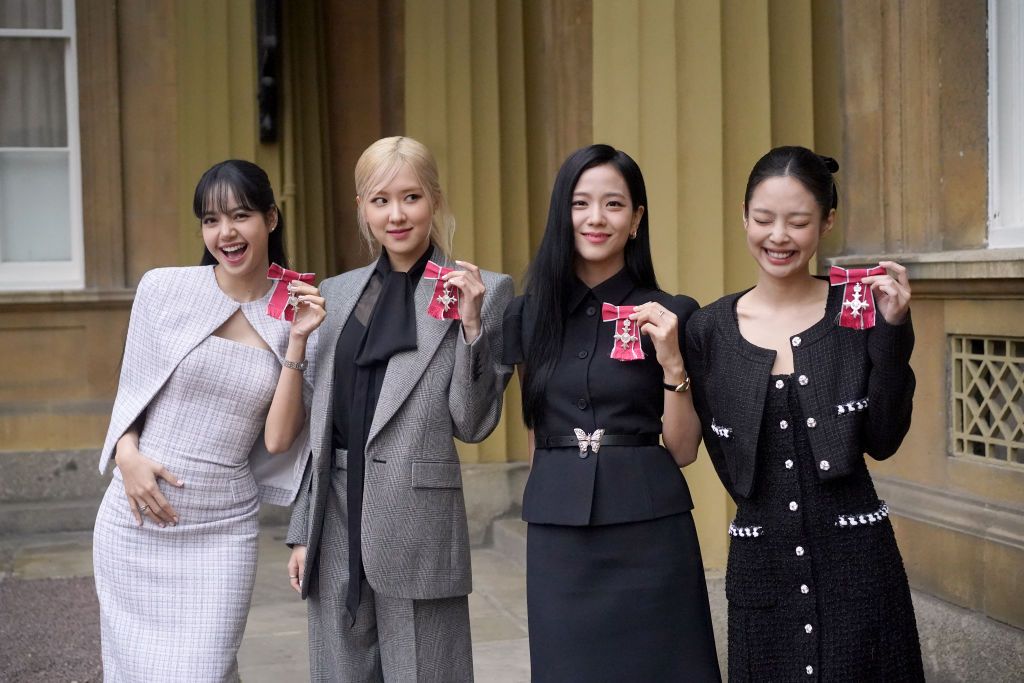 LONDON, ENGLAND - NOVEMBER 22: (left to right) Lisa (Lalisa Manoban), Rose (Roseanne Park), Jisoo Kim and Jennie Kim, from the K-Pop band Blackpink pose with their Honorary MBEs (Members of the Order of the British Empire), awarded to them in recognition of the band's role as COP26 advocates for the COP26 Summit in Glasgow 2021 on November 22, 2023 in London, England. King Charles III conducted the special Investiture ceremony in the presence of the President of South Korea, Yoon Suk Yeol, and his wife, Kim