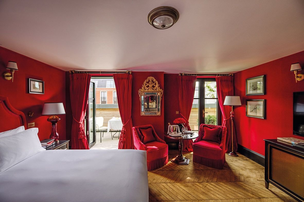 The Twenty Two houses bold and dramatic spaces, including this room which features vivid red hues (Photo: Natalia Miyar Atelier)