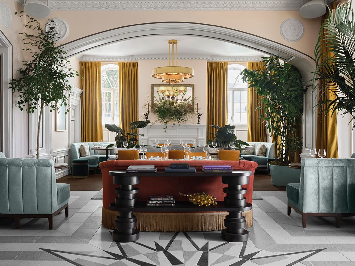 The Dining Room restaurant at The Georgian Hotel in California features vibrant pops of colour and original design details such as large arched doorways and crown mouldings (Photo: Fettle)