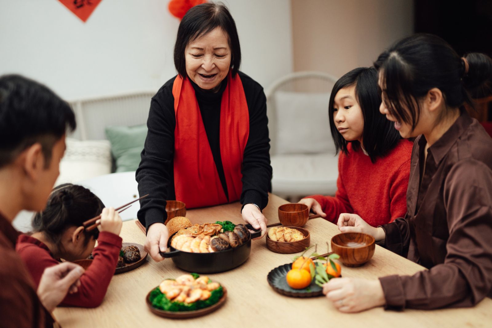 Asian grandmother prepared traditional Chinese Poon Choi for reunion dinner. Traditional Chinese cultures. Chinese Family sharing love and togetherness.
