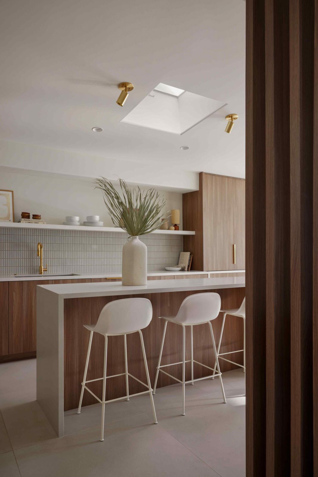 The dated kitchen was reworked to incorporate a long island counter