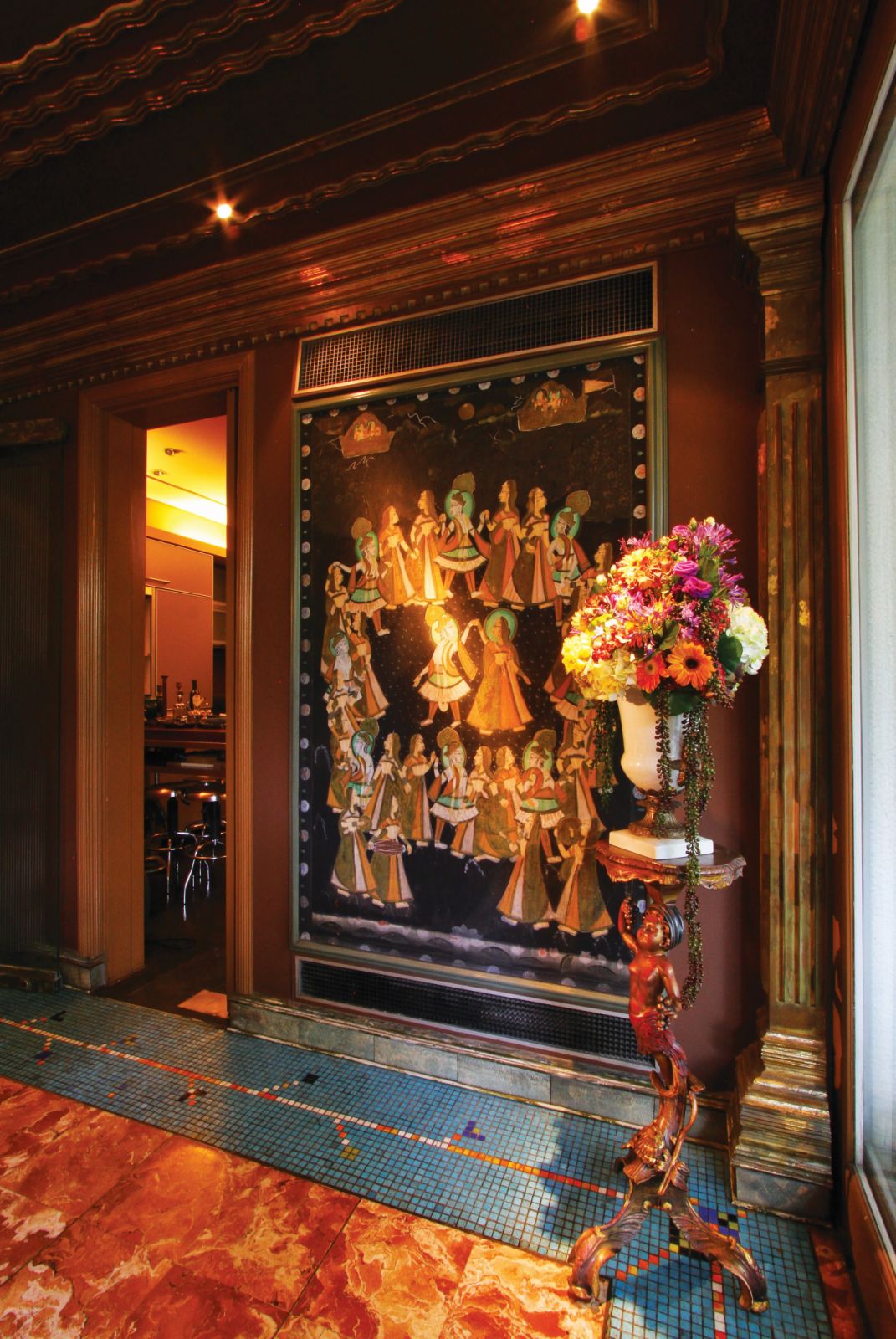 Antique wedding art from India, which shows a maharaja dancing with his many wives, is displayed at the entrance to the kitchen of Ricky Toledo and Chito Vijandre’s home
