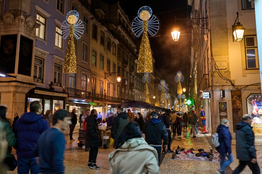 LISBON, PORTUGAL - DECEMBER 01: People walk under Christmas Illuminations depicting angels decorating Rua Augusta on December 04, 2023 in Lisbon, Portugal. The city shows every year a variety of light decorations in streets and buildings, plus the large Christmas tree in Praça do Comercio and several Christmas Markets. (Photo by Horacio Villalobos#Corbis/Corbis via Getty Images)