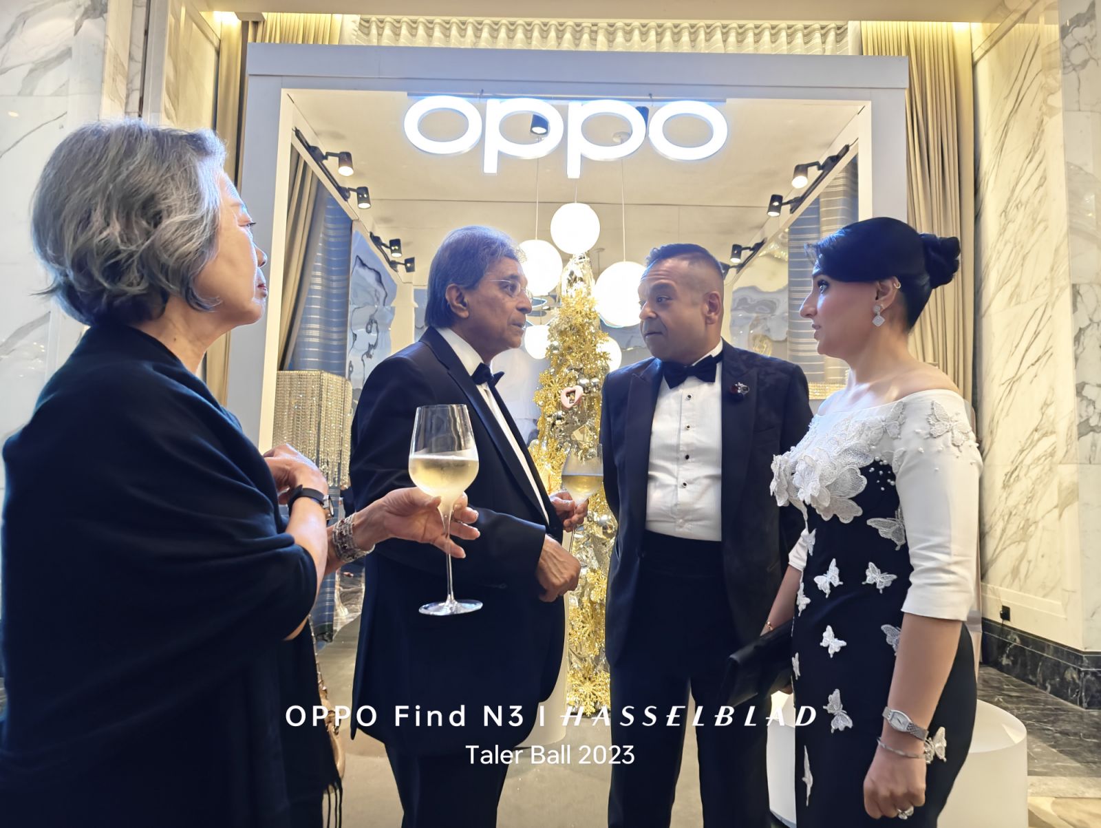 Attendees of the Tatler Ball 2023 in front of the Oppo booth