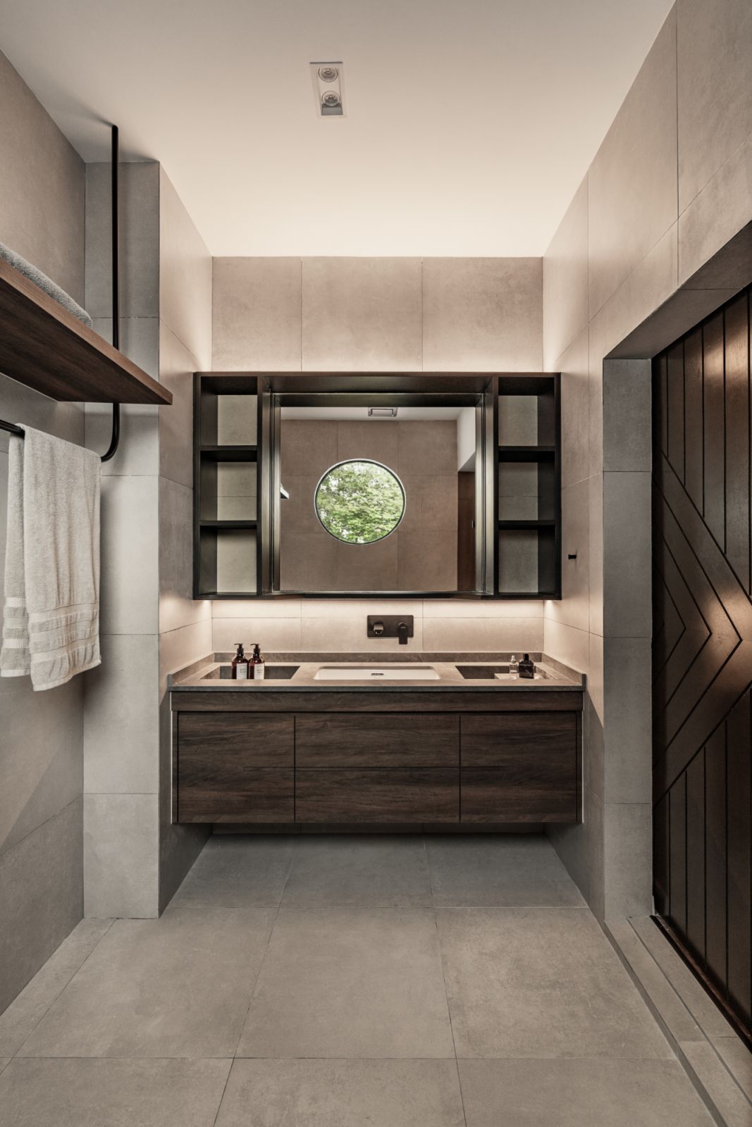 Dark wood is a handsome choice for the bathroom