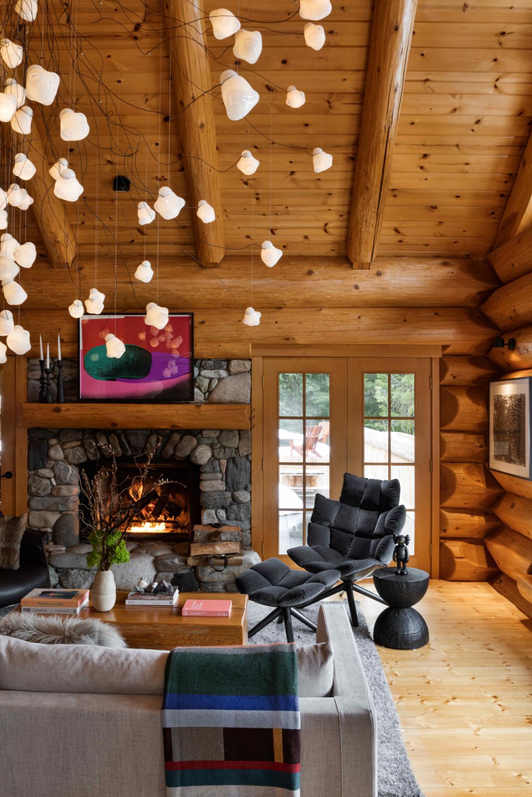 The Bocci lighting fixture that resembles snowfall against the traditional log backdrop