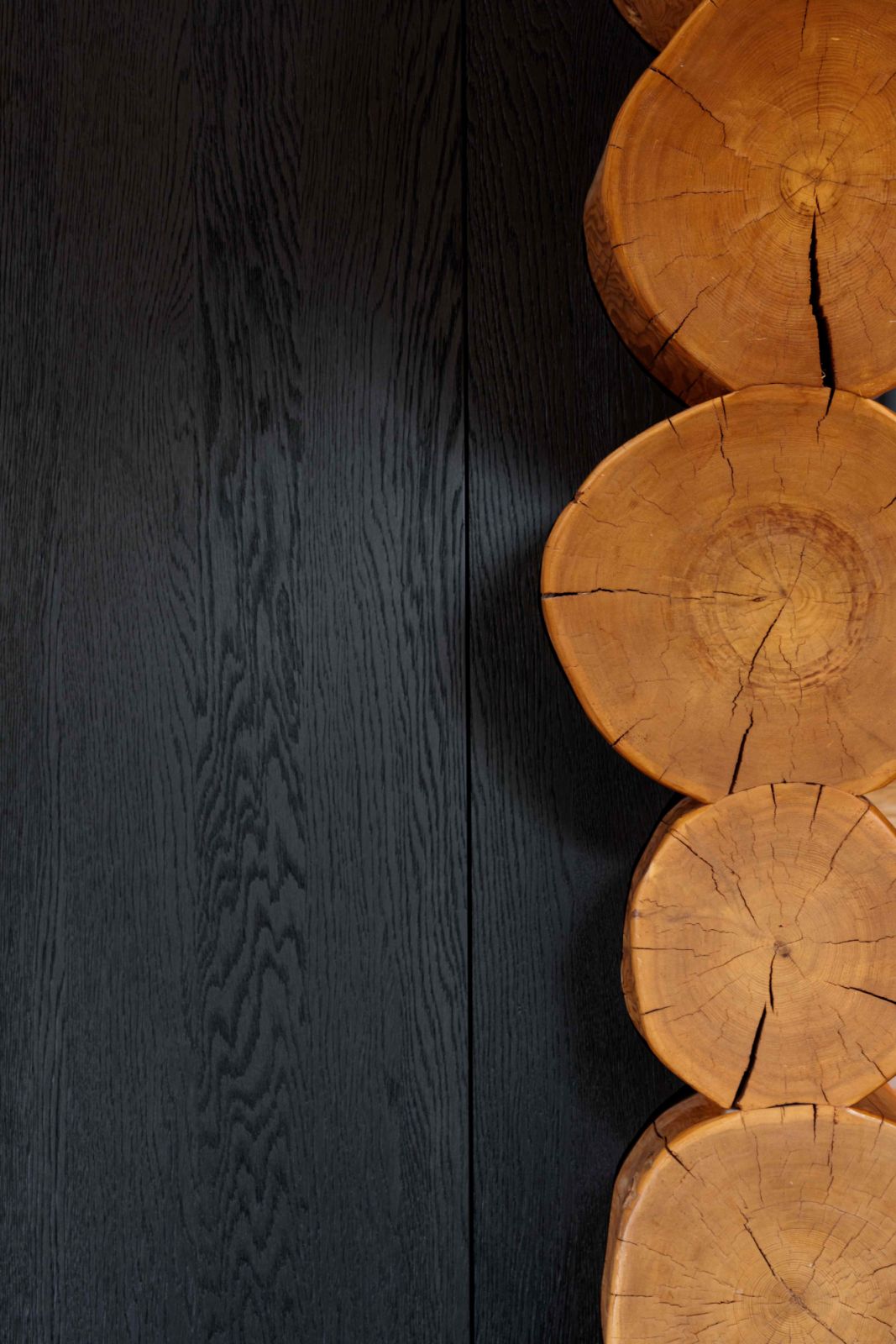 The golden-hued log structure contrasted with dark stained or wire-brushed oak