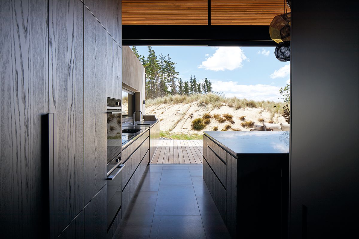 Fitted with sleek Fisher & Paykel appliances, the kitchen enjoys a seamless connection to the outdoor deck