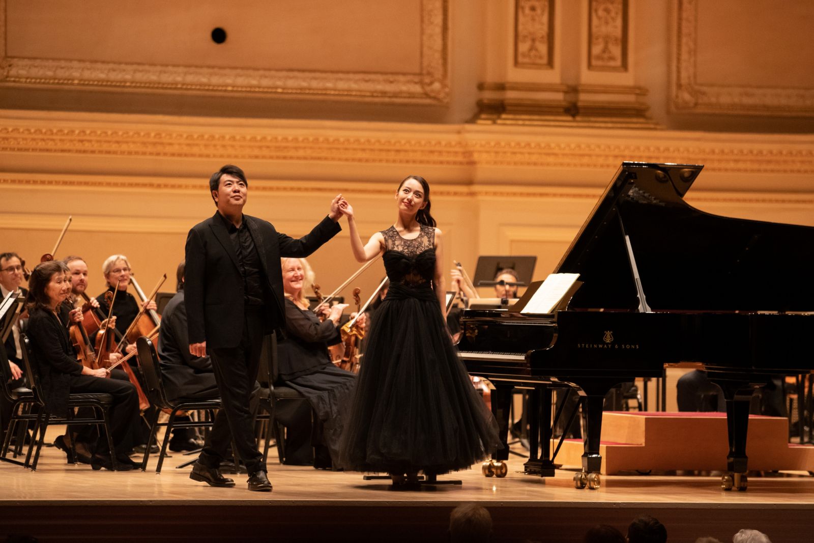 NEW YORK, NY - OCTOBER 12: Pianist Lang Lang and his wife Gina Alice acknowledge the audience during a concert at Carnegie Hall on October 12, 2023 in New York City. (Photo by Liao Pan/China News Service/VCG via Getty Images)
