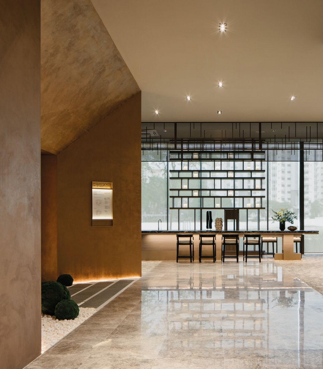 The bronze finish on the walls next to the steps create an enigmatic look, enhanced by the use of backlighting along the the perimeter of the space