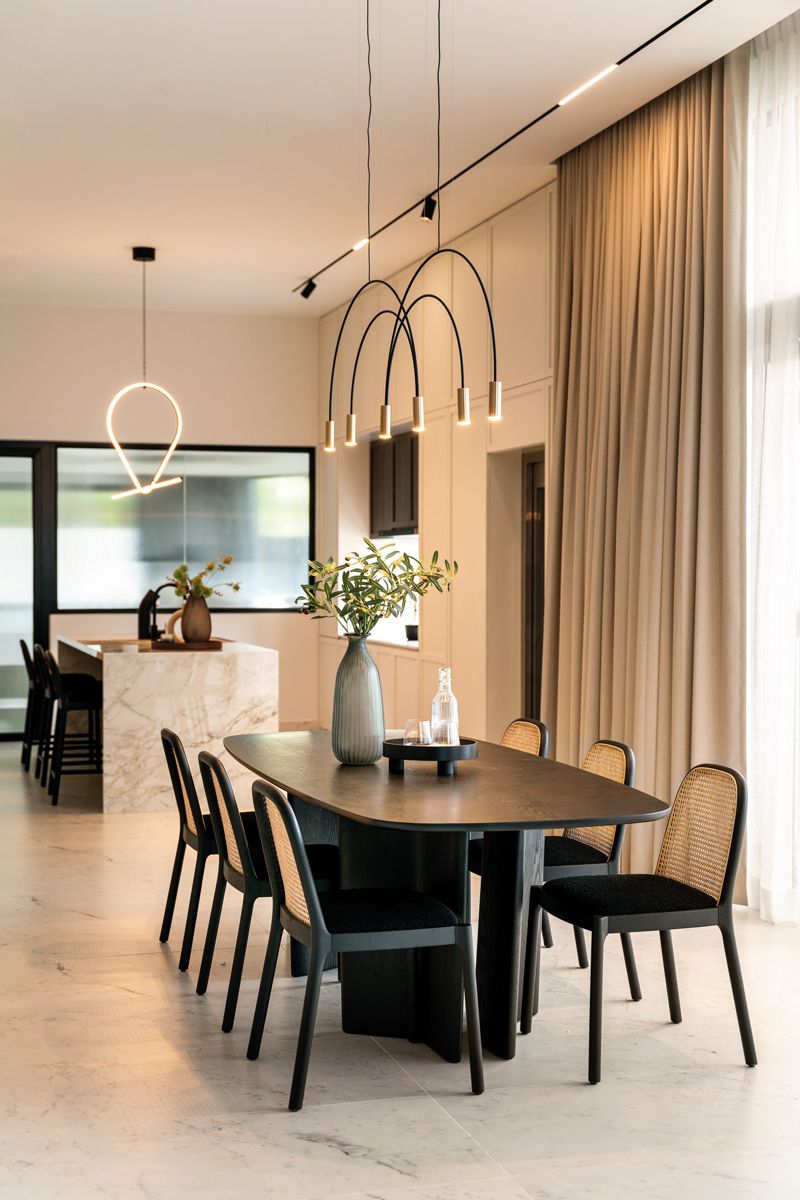 The woven detailing on the dining chairs adds a warm and rustic touch to the dining area