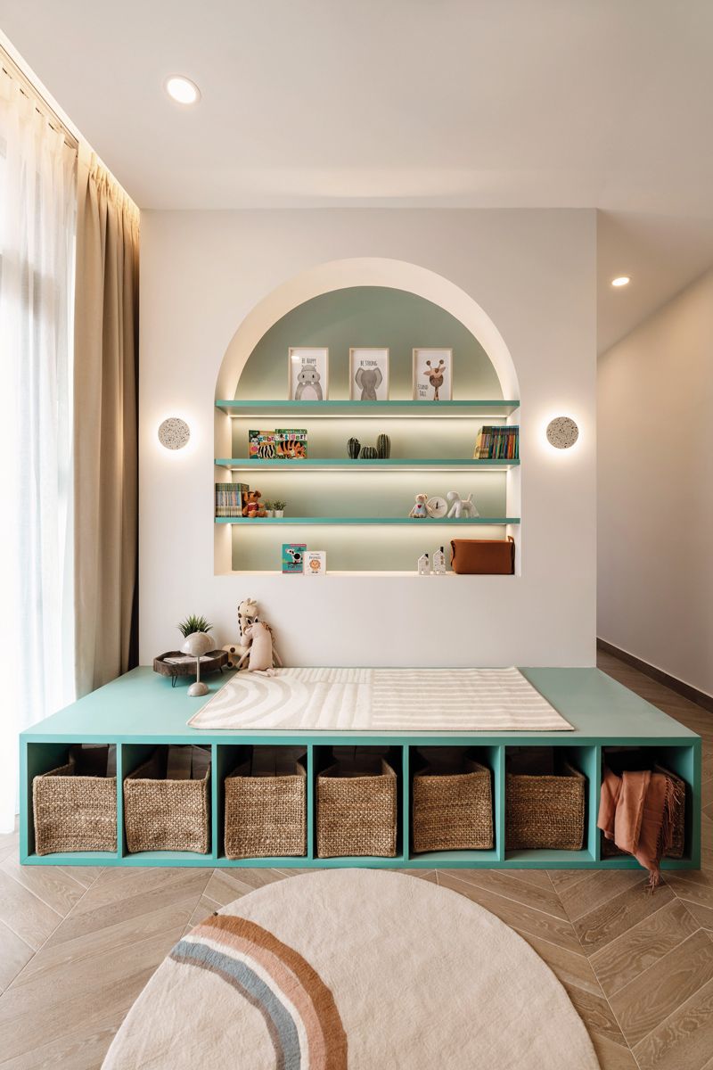 Mint green hues on the shelves and platform add colour to the play area