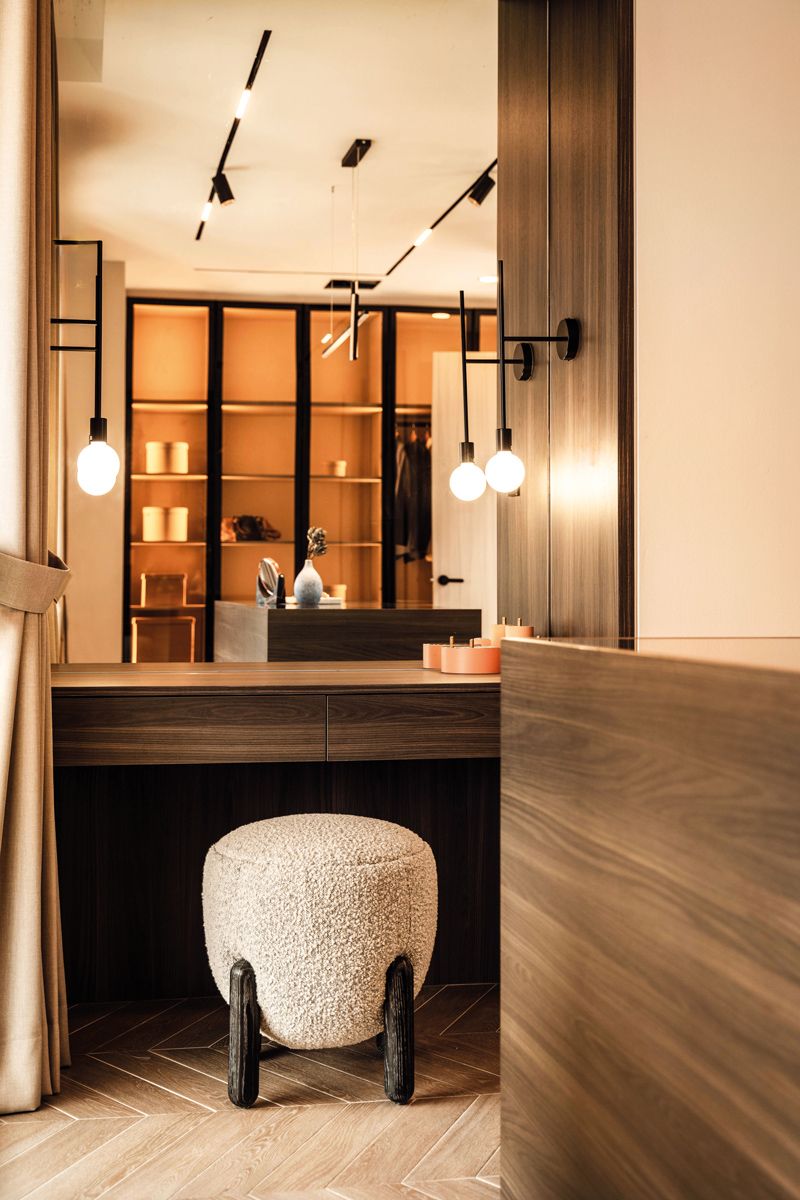 Herringbone-patterned wood flooring contributes to the layered look of the home