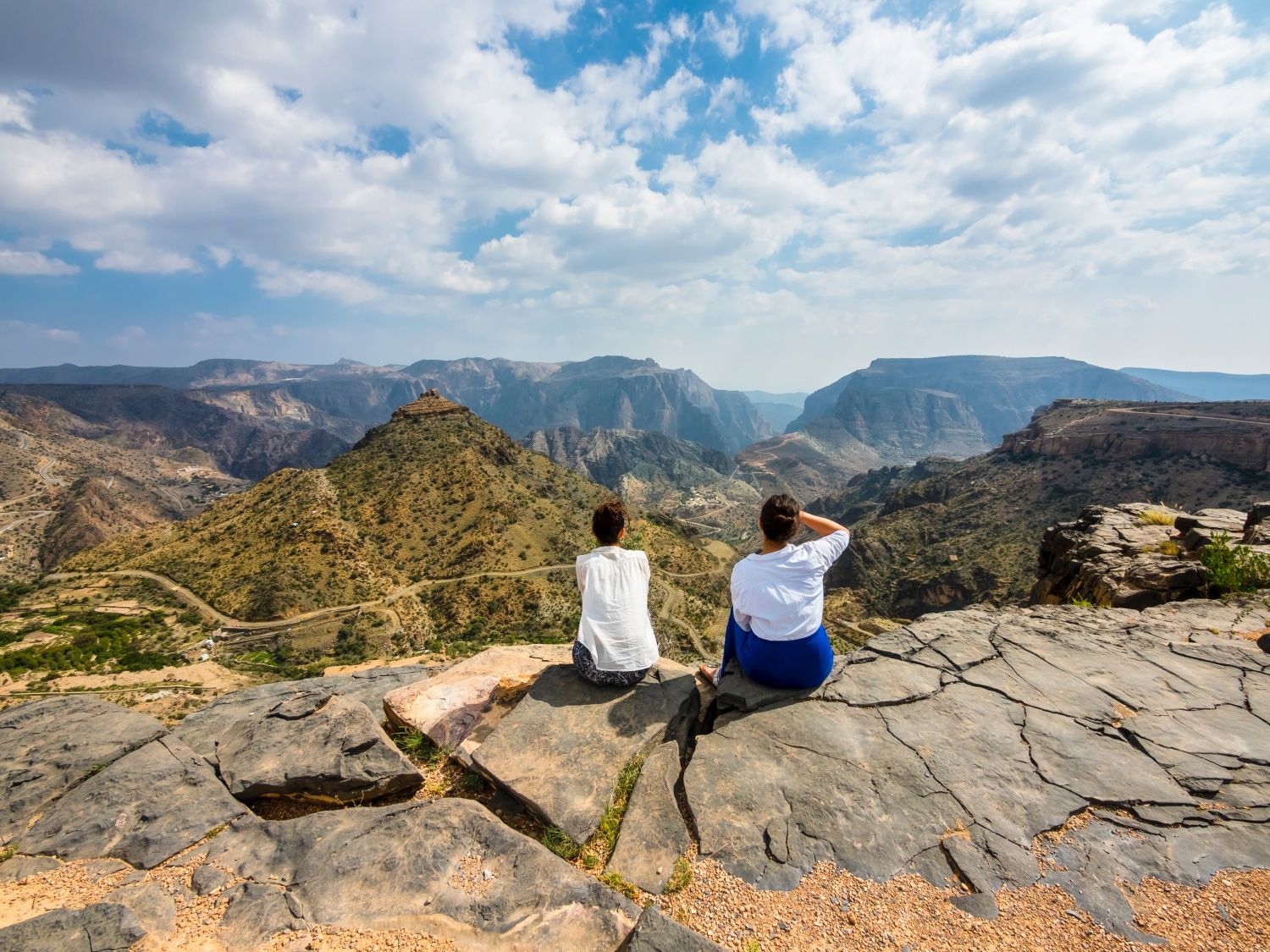 Zwei junge Frauen schauen auf die Berge von Jebal Akhdar, Sultanat Oman, Arabien, Mittlerer Osten