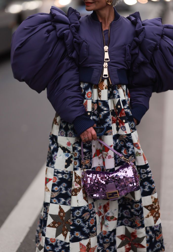PARIS, FRANCE - JANUARY 25: Grece Ghanem seen wearing a purple Fendi sparkling baguette, a purple cropped puffer jacket, a patterned long dress and dark shades before the Viktor & Rolf show on January 25, 2023 in Paris, France. (Photo by Jeremy Moeller/Getty Images)