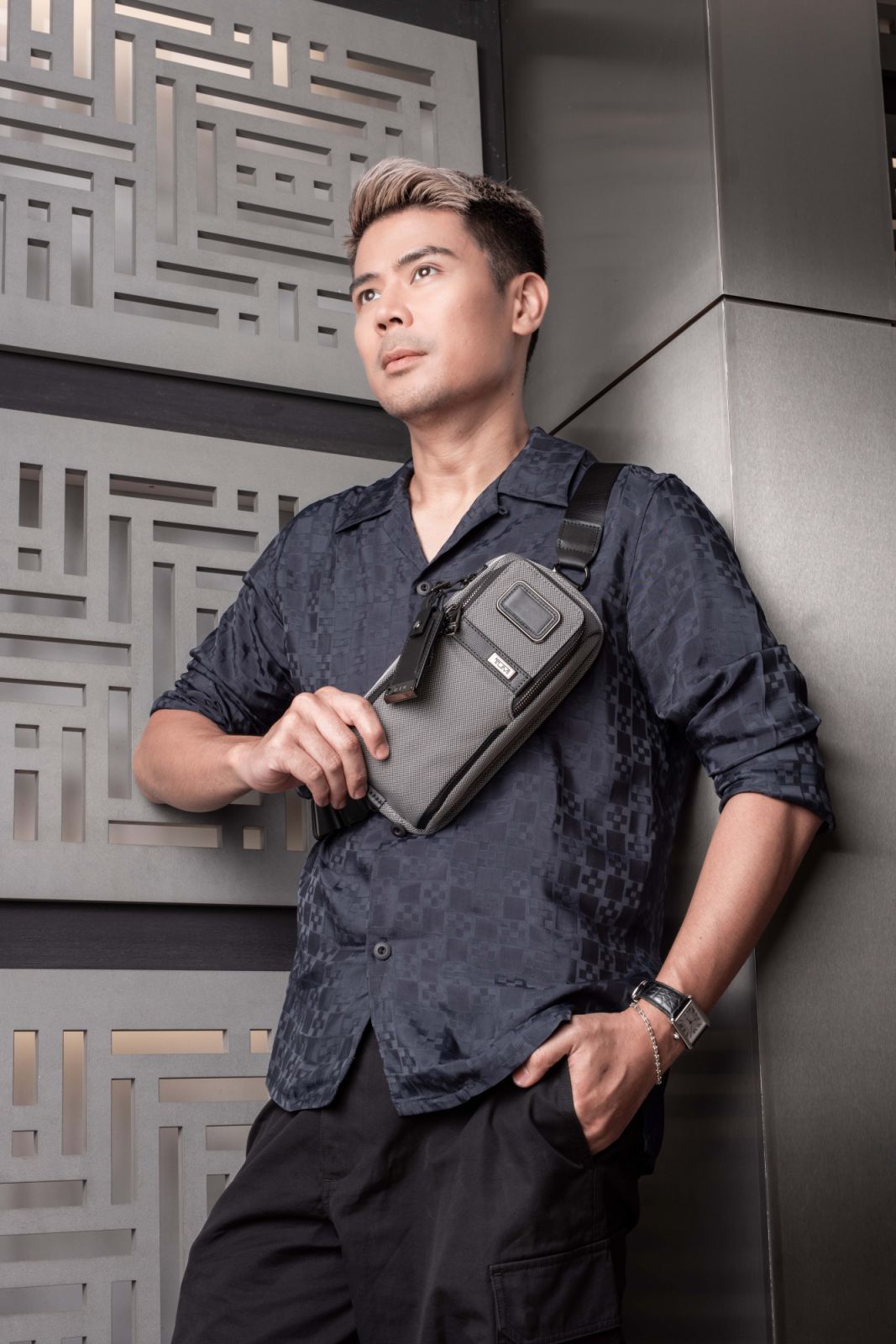 Awal sporting the Tumi Alpha X Compact Sling in Meteor Grey
