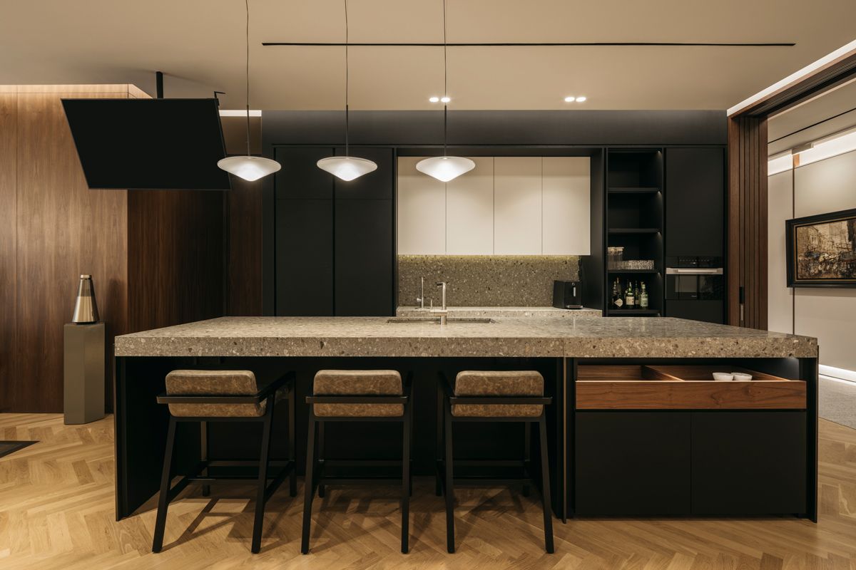 The large kitchen island and bar counter turn the pantry into a social zone