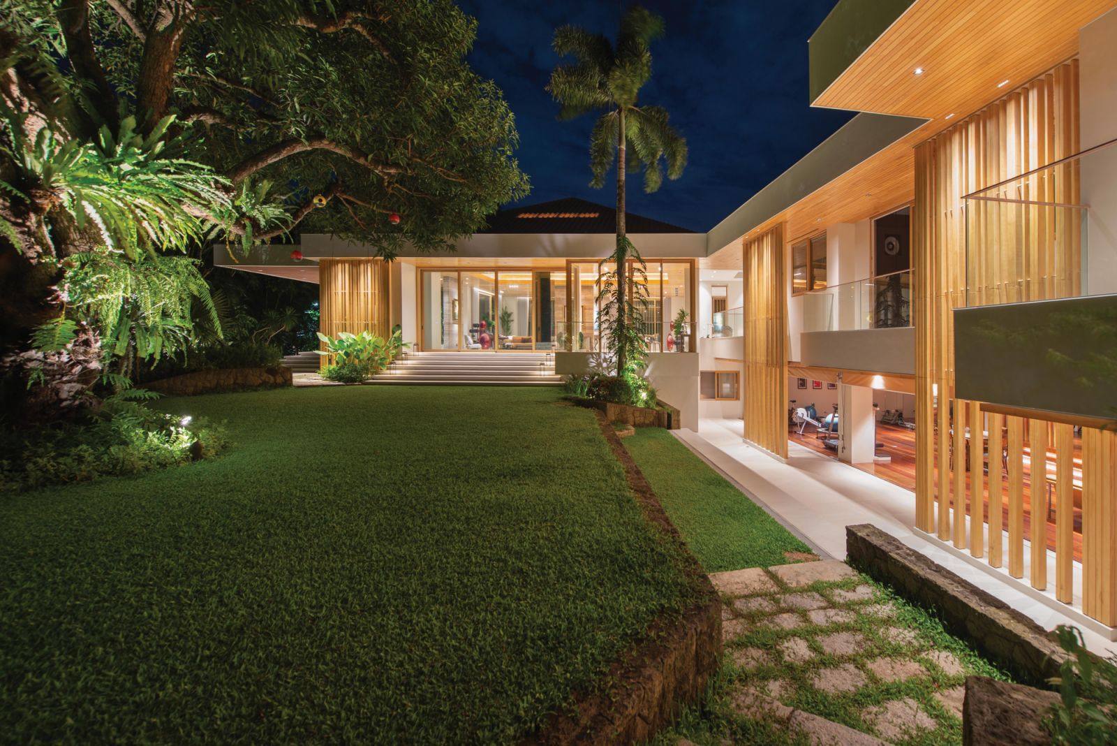 At night, the house appears to be glowing from within, with dramatic lighting peeking through the huge glass windows and doors (Photo: Greg Mayo)