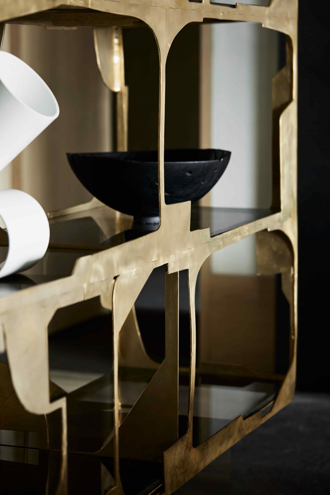 The limited edition designer bookshelf exudes raw elegance with its jagged bronze shelving