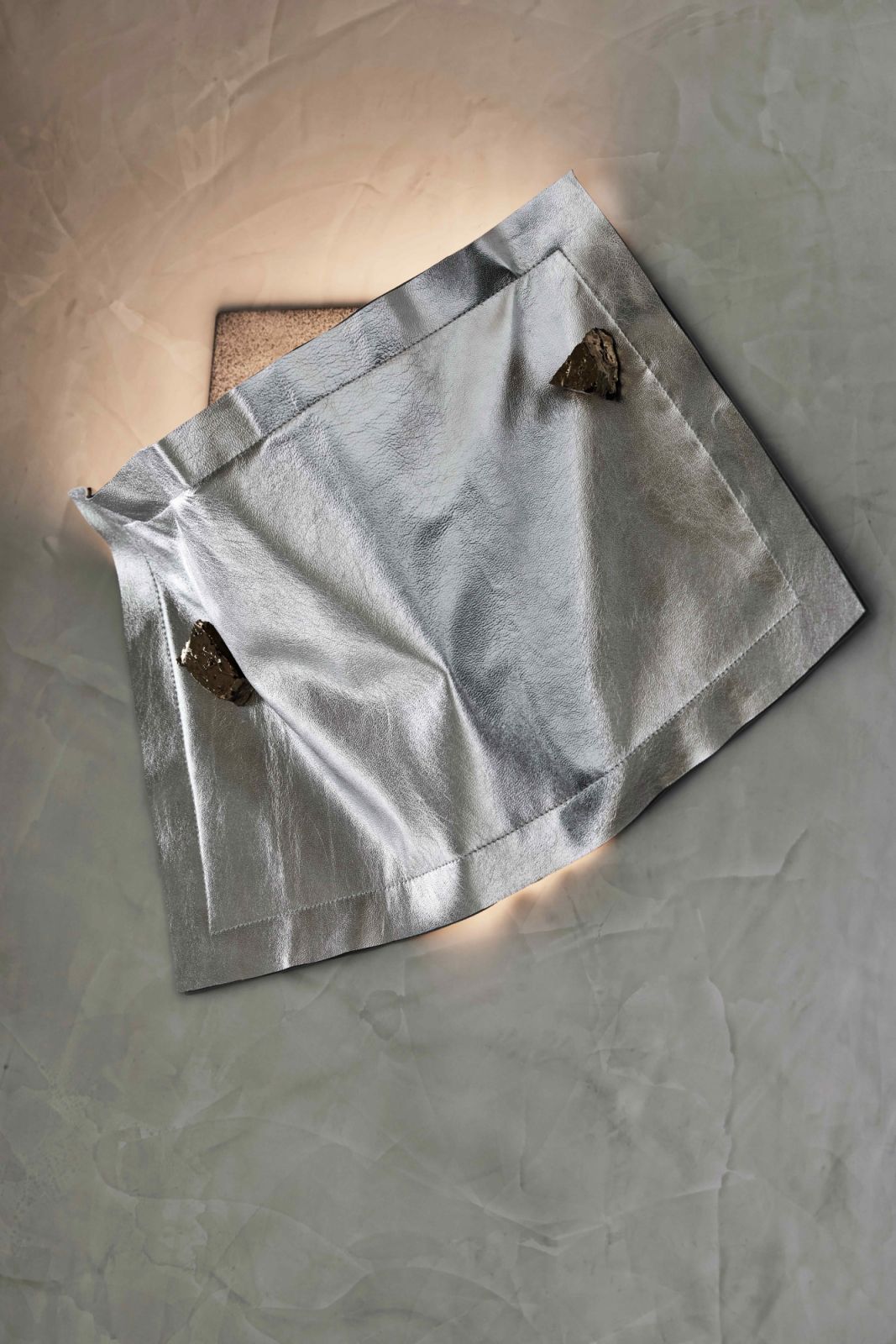 Composed of textured brass back plate, topped with ceramic-glazed recycled brick fragments