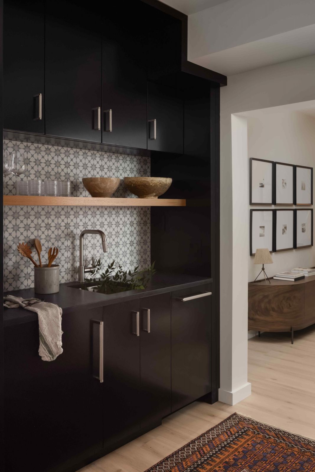 Grey Moroccan tile backsplash with the dark basement kitchen cabinets