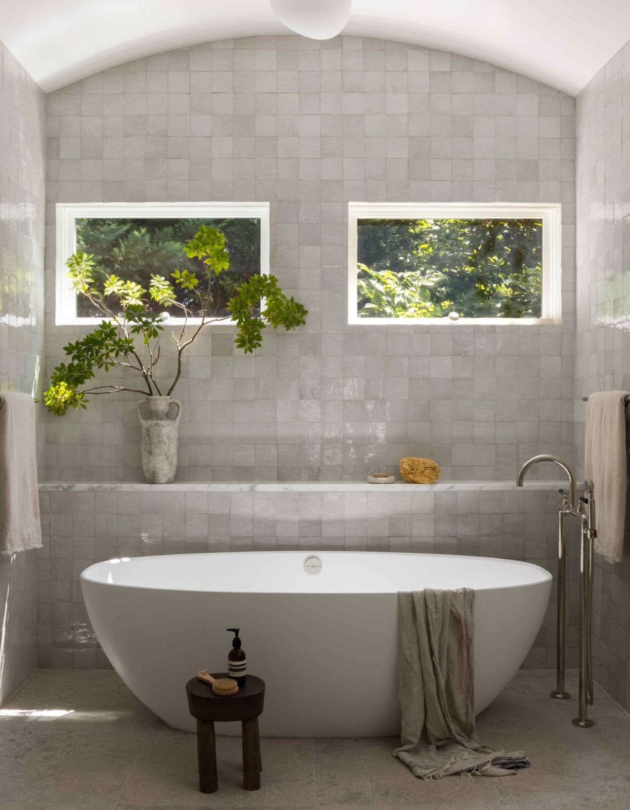Zellige tiles in the primary bathroom advanced the tonal transition