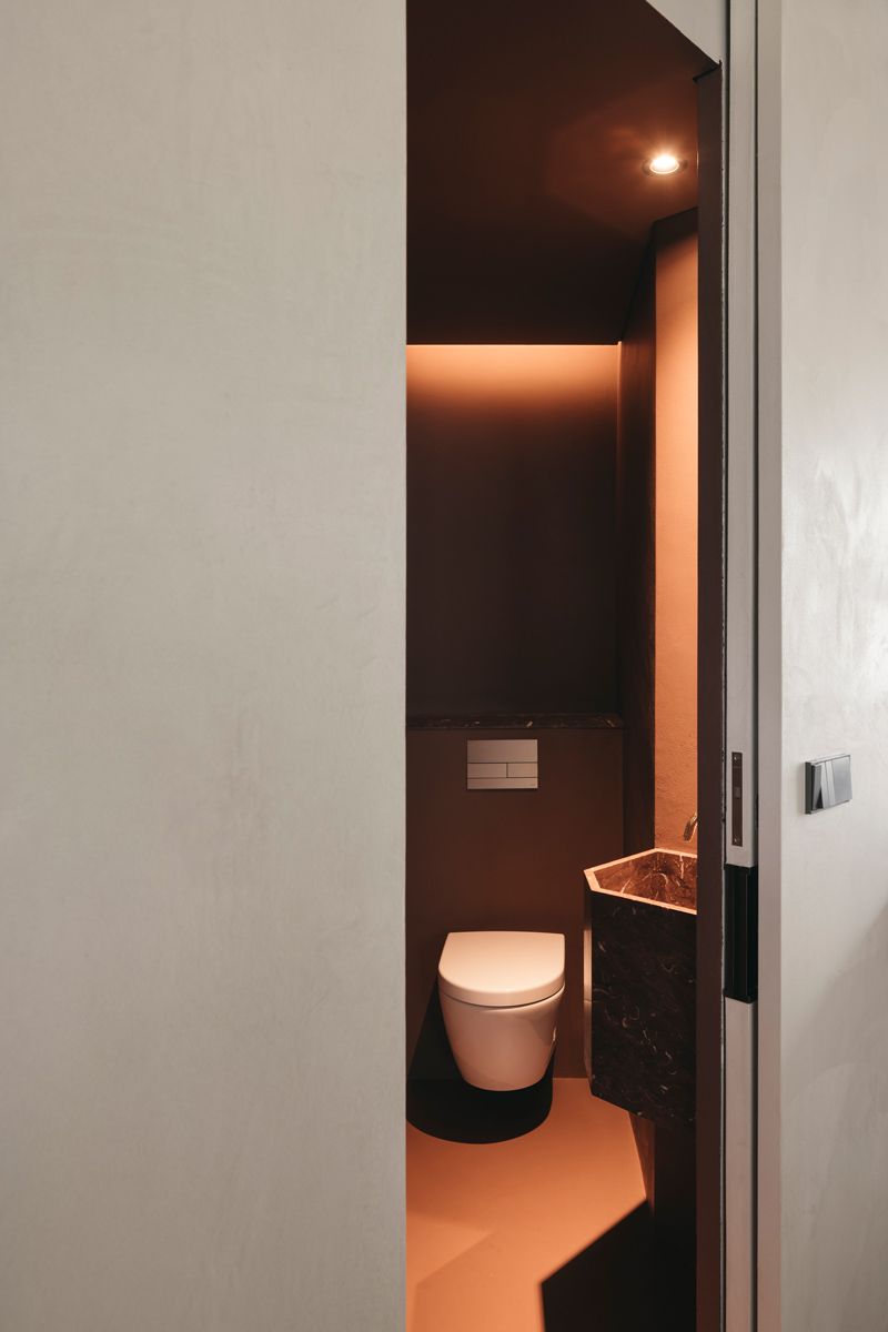 The design of the powder room breaks away from the minimalism adhered by the rest of the interior
