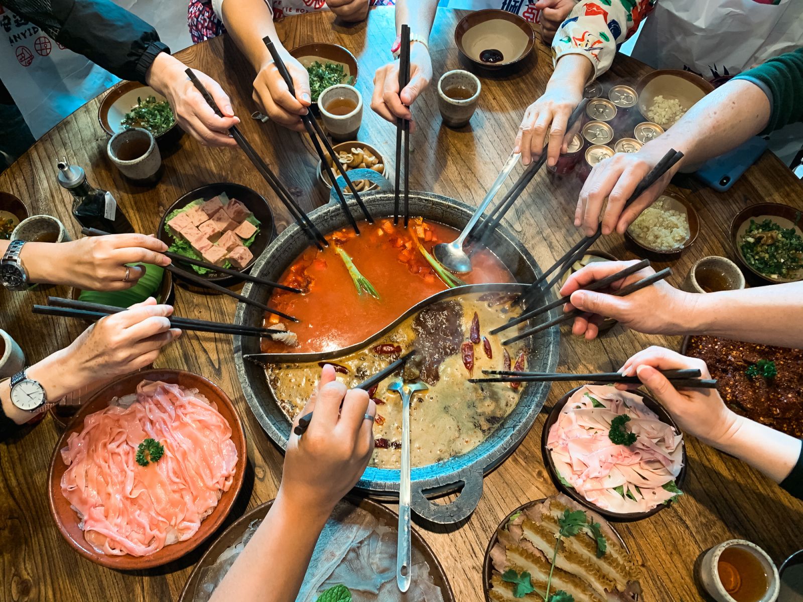 A group indulging in hot pot with an array of fixings. (Photo: Getty Images)
