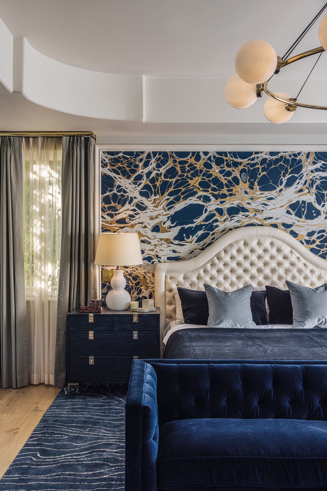 Blue hues lend a regal air to the guest room