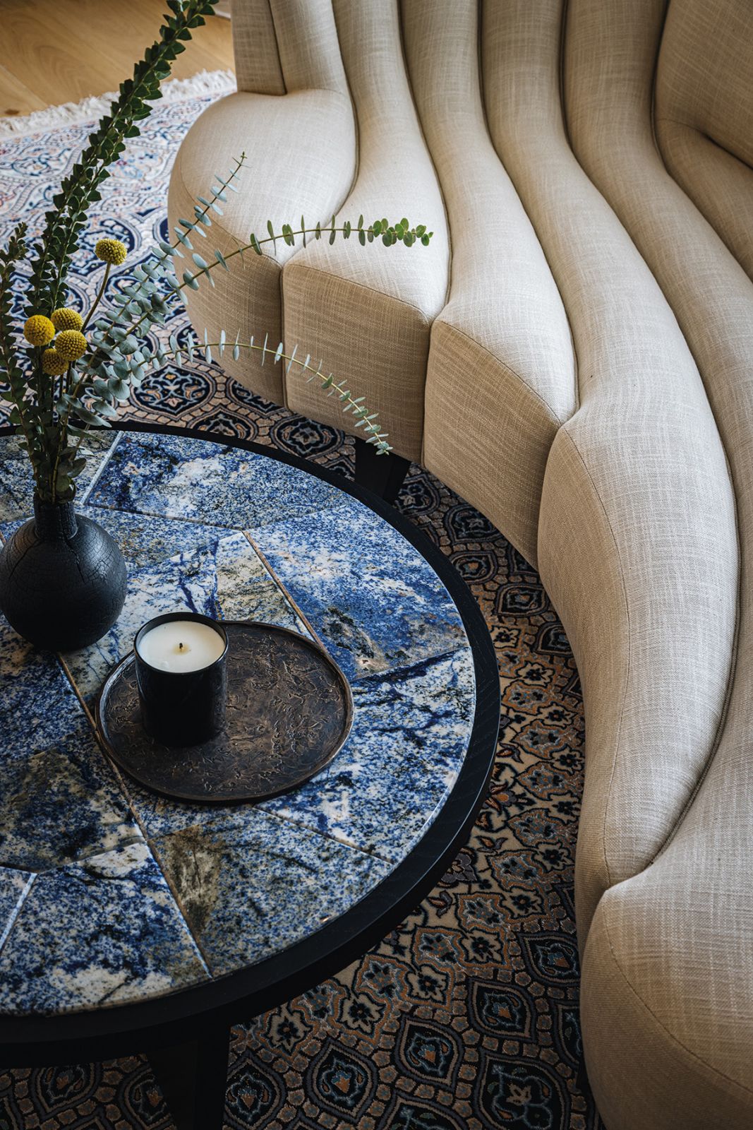 The reception room features a stunning table inlaid with intricately patterned Royal Blue marble