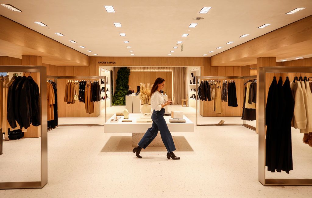 VALENCIA, COMMUNITY OF VALENCIA, SPAIN - DECEMBER 02: A girl in a Zara megastore at Boulevard Austria de Valencia, on 02 December, 2022 in Valencia, Valencian Community, Spain. The concept of this megastore replicates the model of other megastores recently opened by Zara in Battersea (London) and Plaza de España (Madrid), which offer a full digital experience to customers with robots for picking up online orders. They also combine all its traditional sections for men, women and children, along with new lin