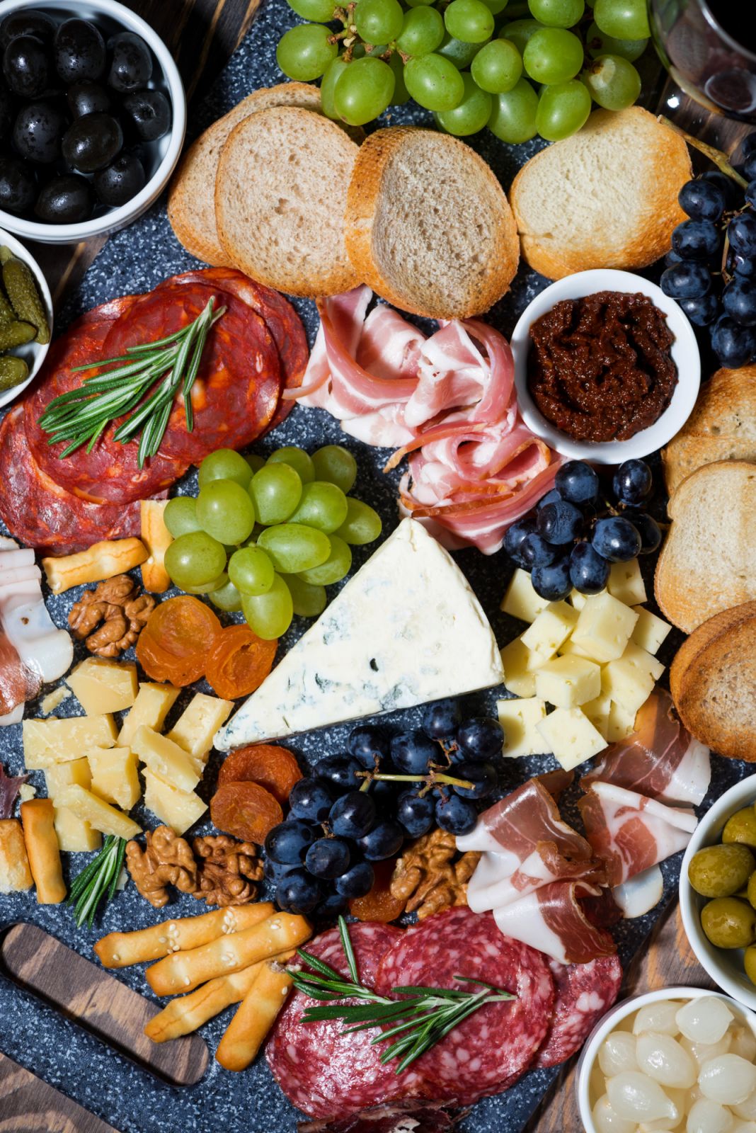 A grazing platter of cured meats, cheeses, and olives