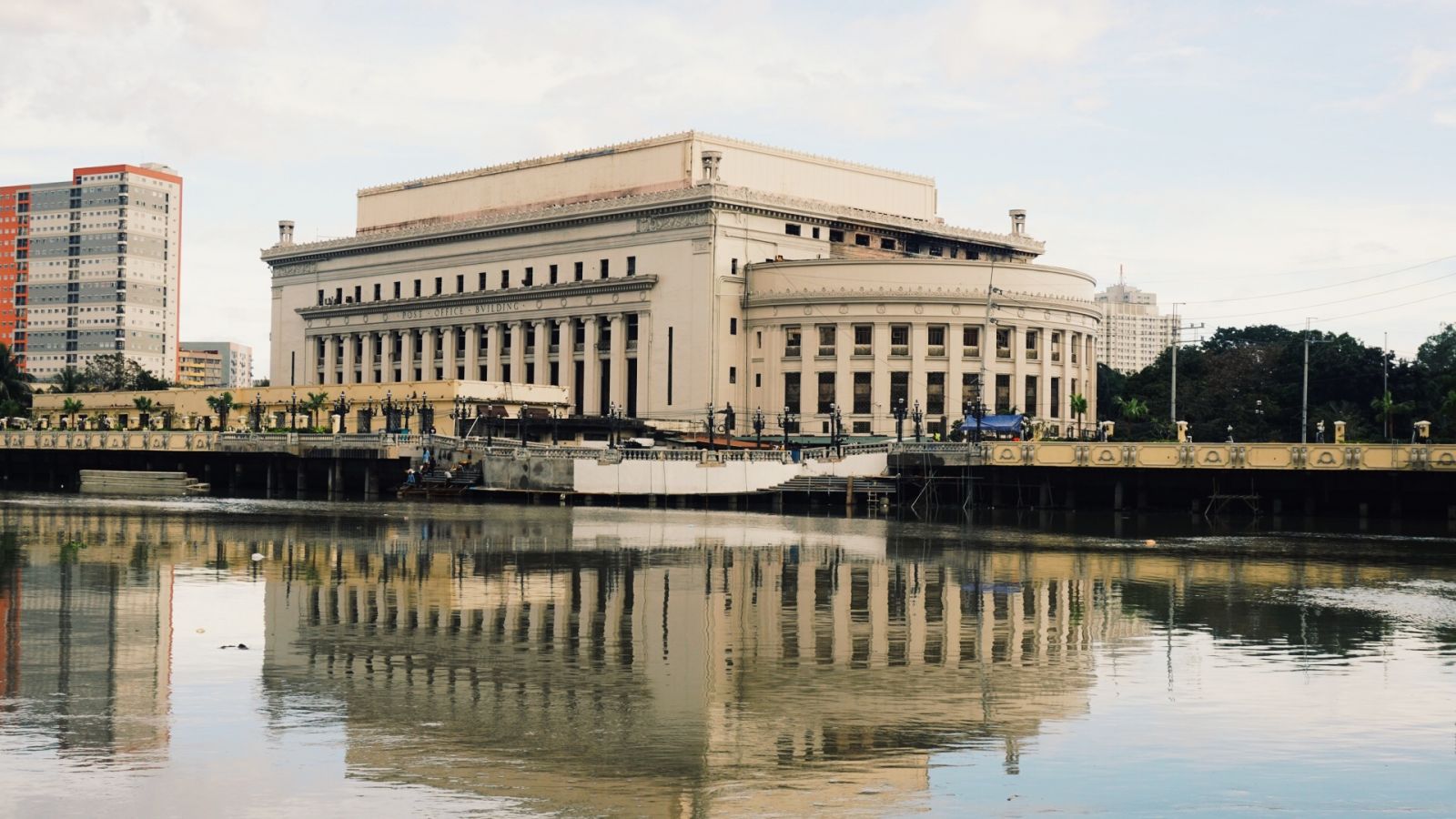 Pasig river mirrors the ravaged shell of the Manila Post Office which was consumed by fire in May 2023