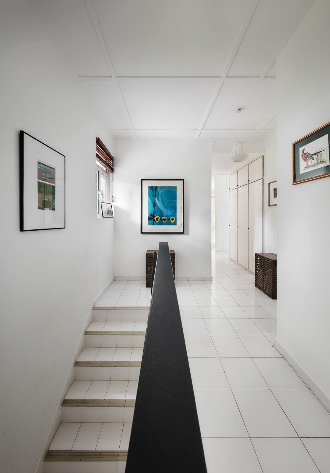 The black-framed artworks reference the architectural design of this historical property, in keeping with the home’s overall monochromatic palette that's enlivened by artworks