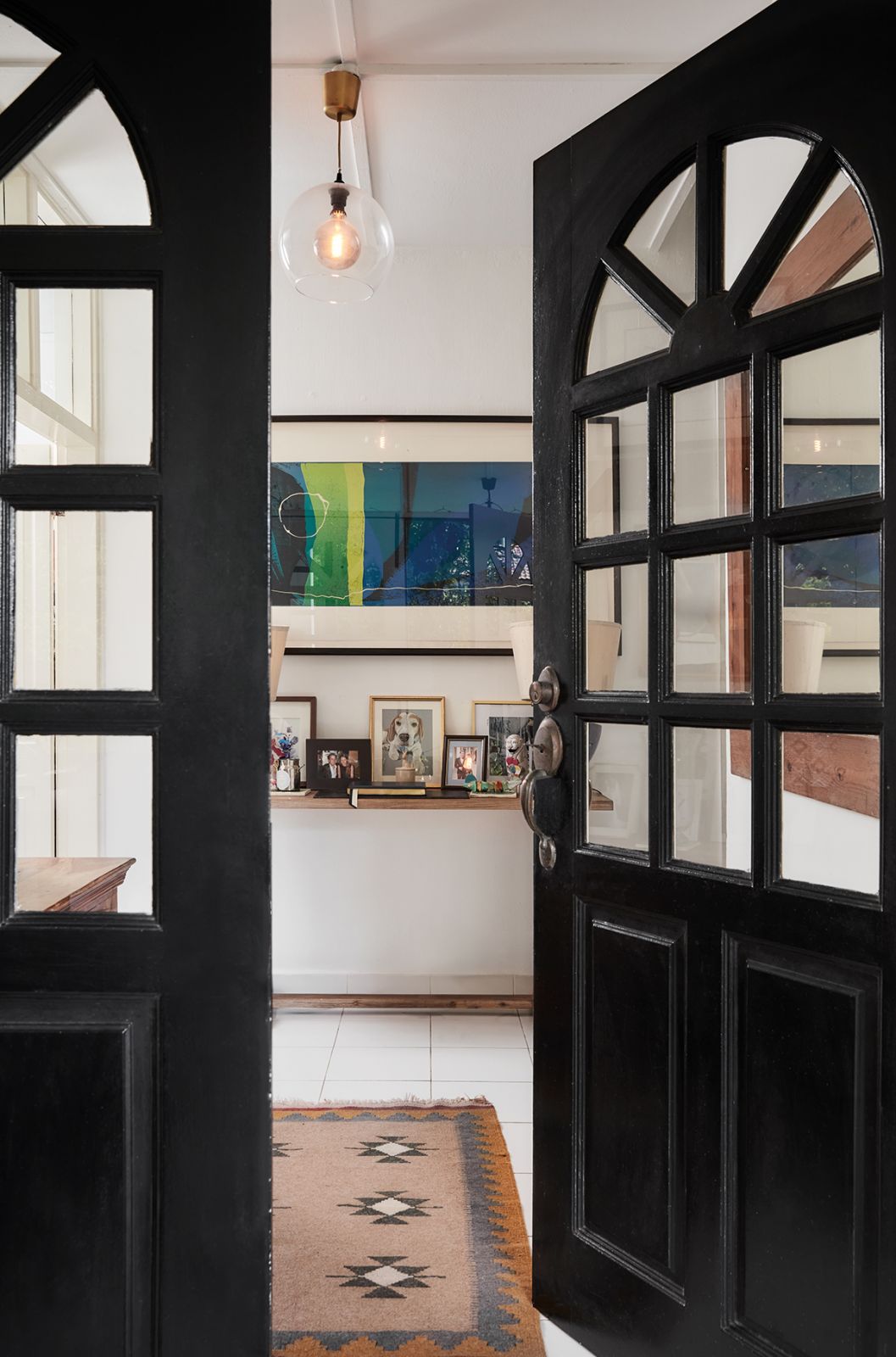 A console lined with family photos greets guests at the entryway