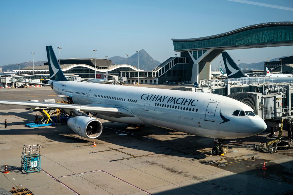 A Cathay Pacific plane is parked at the gate at Hong Kong International Airport in Hong Kong, China, on January 9, 2023. (Photo by Vernon Yuen/NurPhoto via Getty Images)